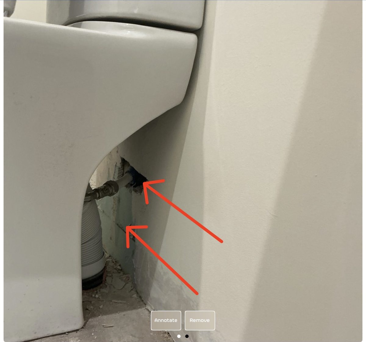 Unfilled gap behind a guest-toilet WC exposing the plumbing, flagged during a SnagSafe inspection in Dublin