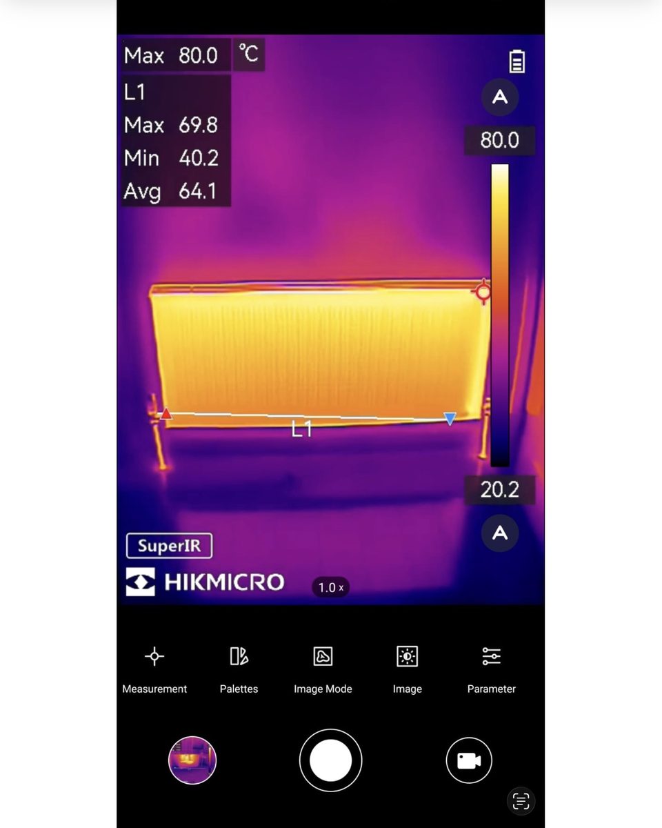 HIKMICRO thermal-imaging camera being used by a SnagSafe inspector to scan a radiator for cold spots